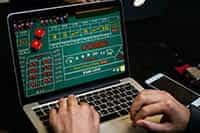 A craps game being played on a laptop.