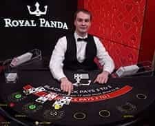 An image of a live dealer setting up a blackjack game.