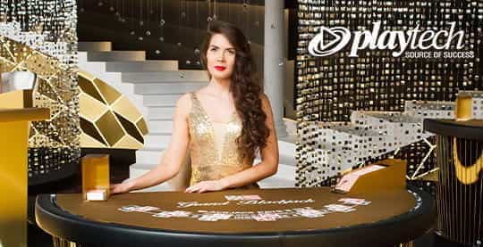 A live dealer from Playtech wears gold formal attire and smiles politely.