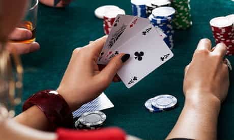 A player's hand holding three cards.