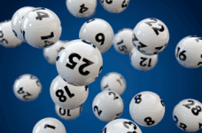 Numbered lottery balls hang in the air.