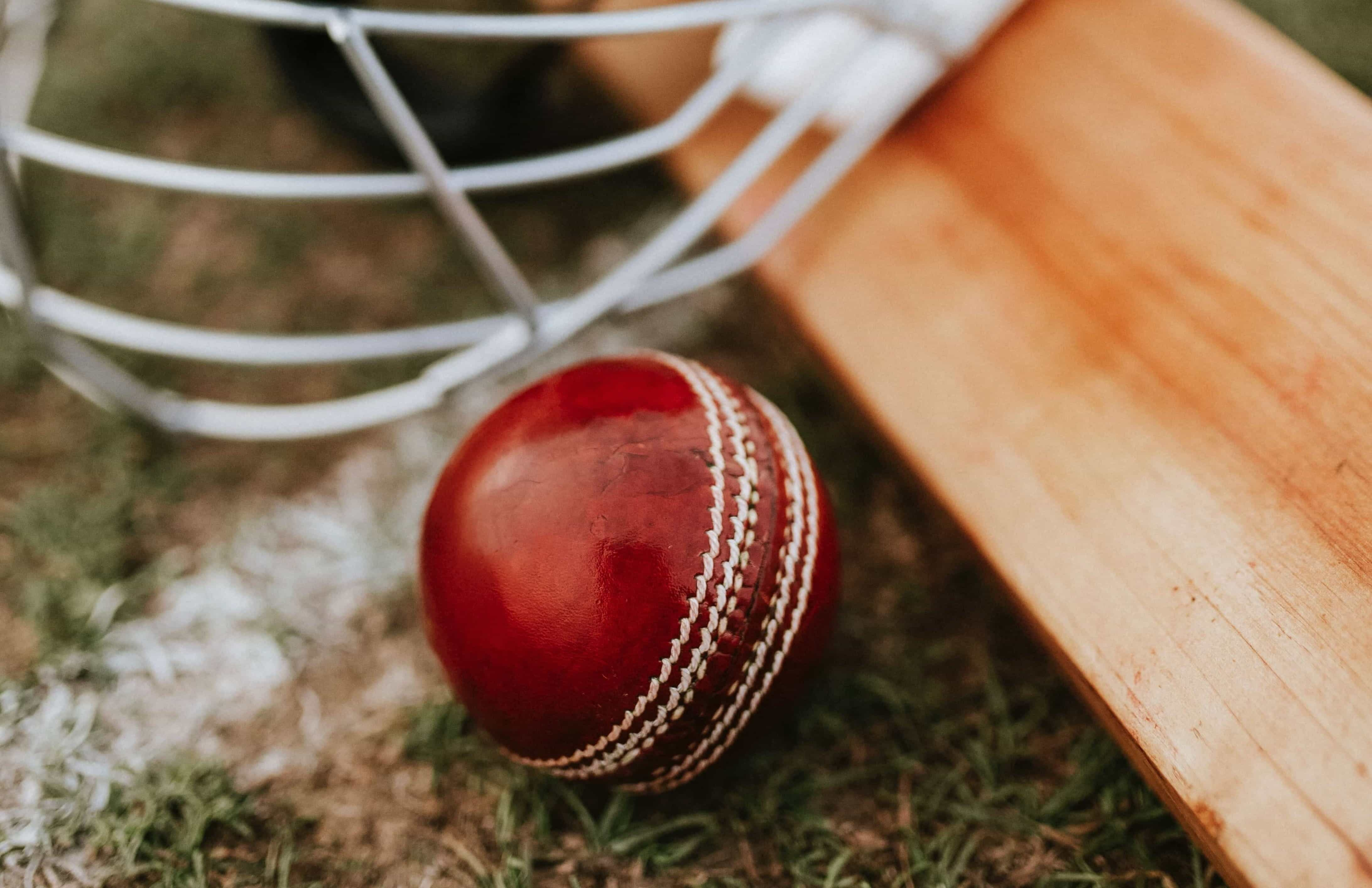 Cricket ball, bat and helmet.