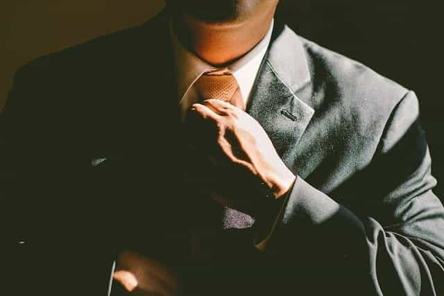 Man tying a tie.