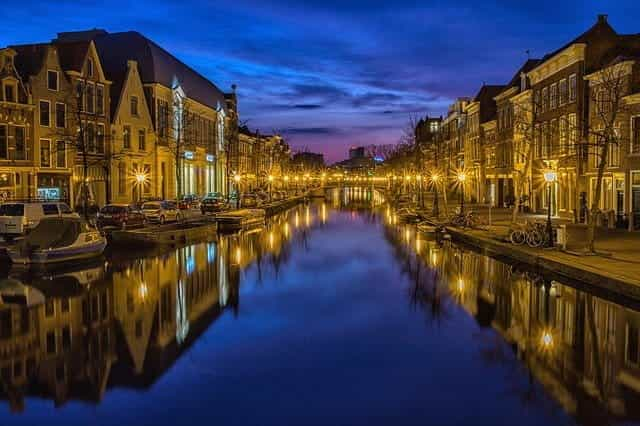 A canal in Amsterdam at night time.