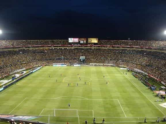 A crowded soccer stadium at night.