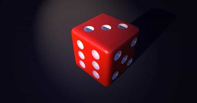 A red 3D dice on a black background.