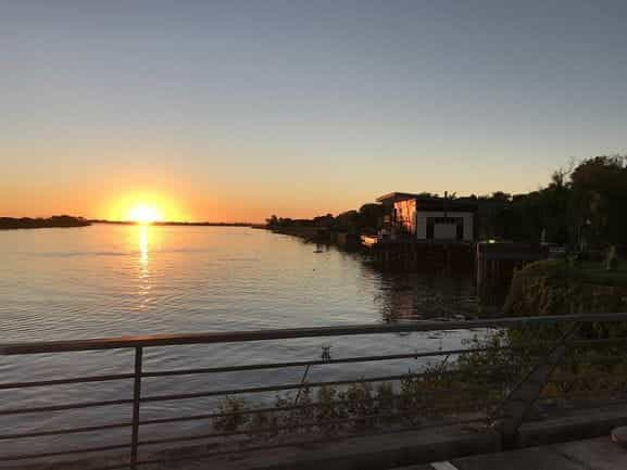 The sun sets over the water in Paraguay.