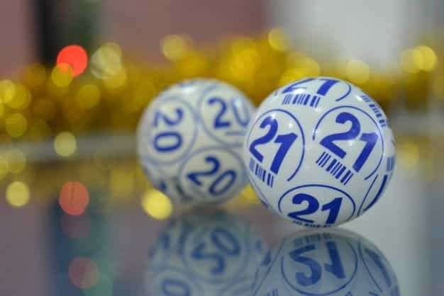 Two numbered bingo lottery balls.