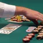 A dealer counts out chips during a hand of Texas Hold’em.