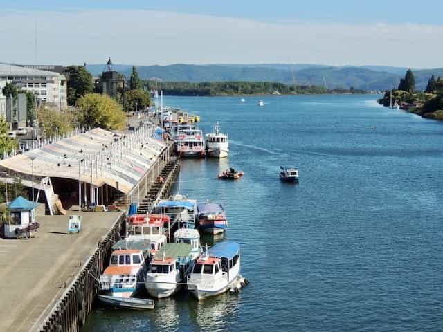 Boats along a river dock in Valdivia, Chile.