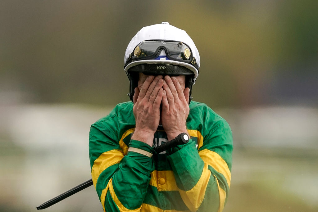 Paul Townend covers his face after riding I Am Maximus to Grand National victory.