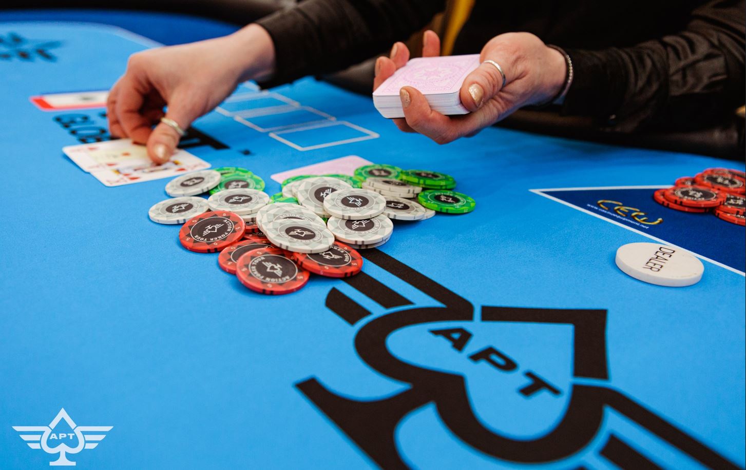 Dealers hands a flop at a poker table.