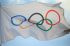 The Olympic flag flutters in the wind.