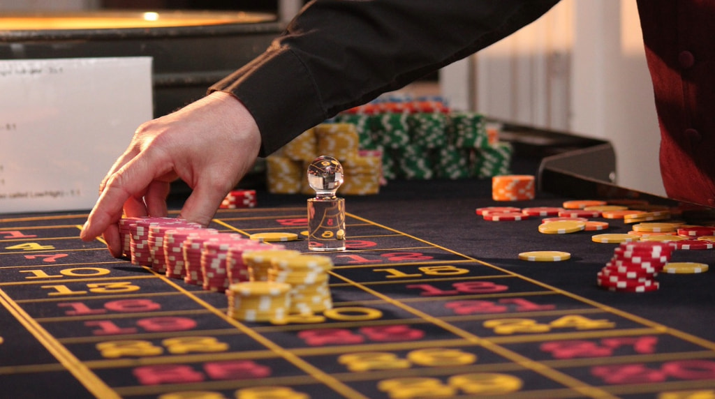 A Person Betting on Roulette with Chips