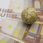 Euro Banknotes with a Stone on Top to Limit Them