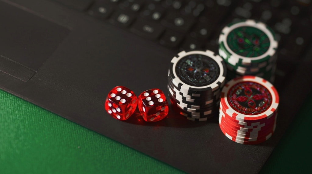 Laptop with Casino Chips and Dice