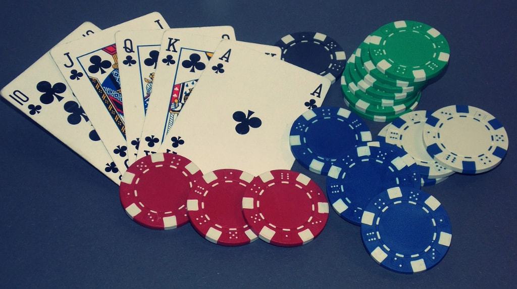 A Royal Flush and Casino Chips on a Gaming Table