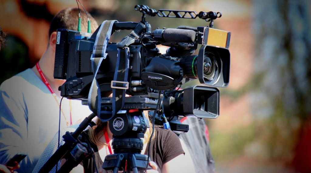 A person holding a big camera