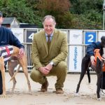 GBGB Chief Executive Mark Bird flanked by two racing greyhounds and their handler