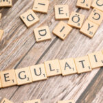 Scrabble Game Tiles Spelling the Word Regulation