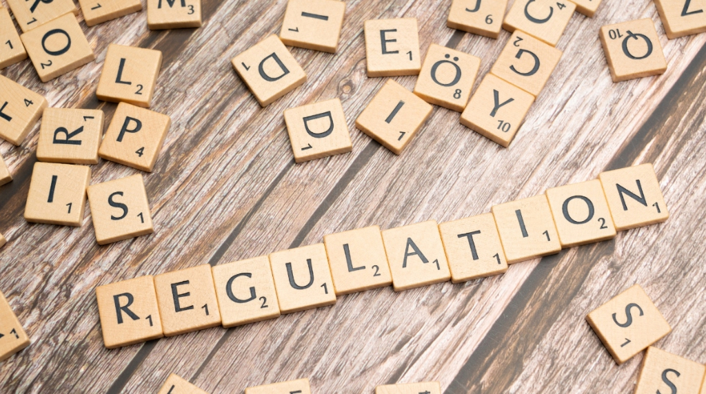 Scrabble Game Tiles Spelling the Word Regulation