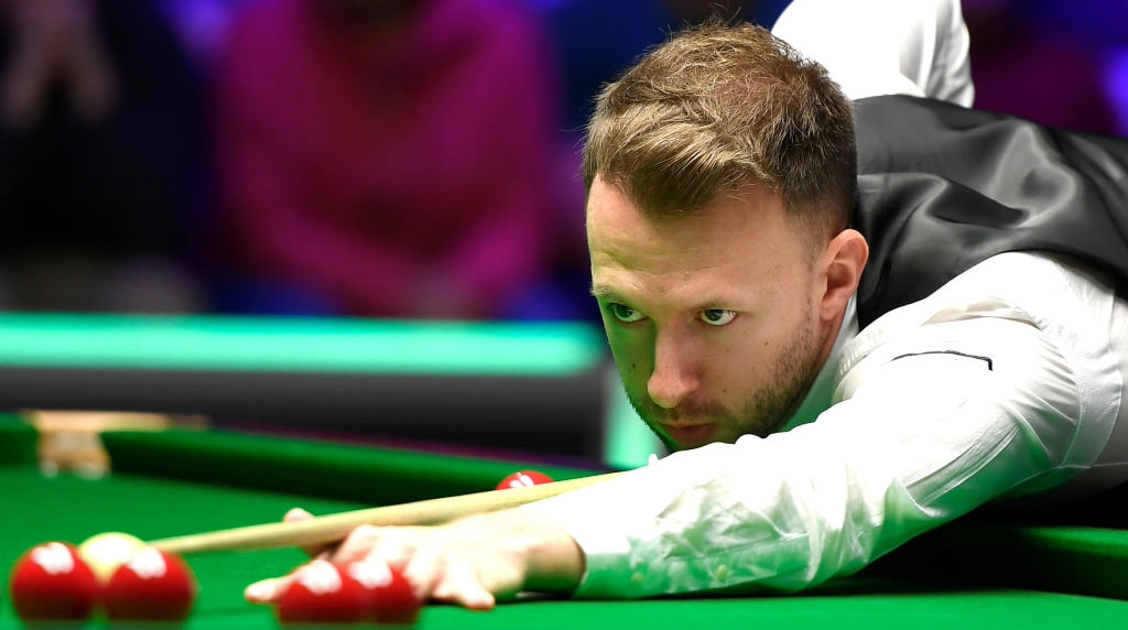 Snooker star Judd Trump lines up a shot.