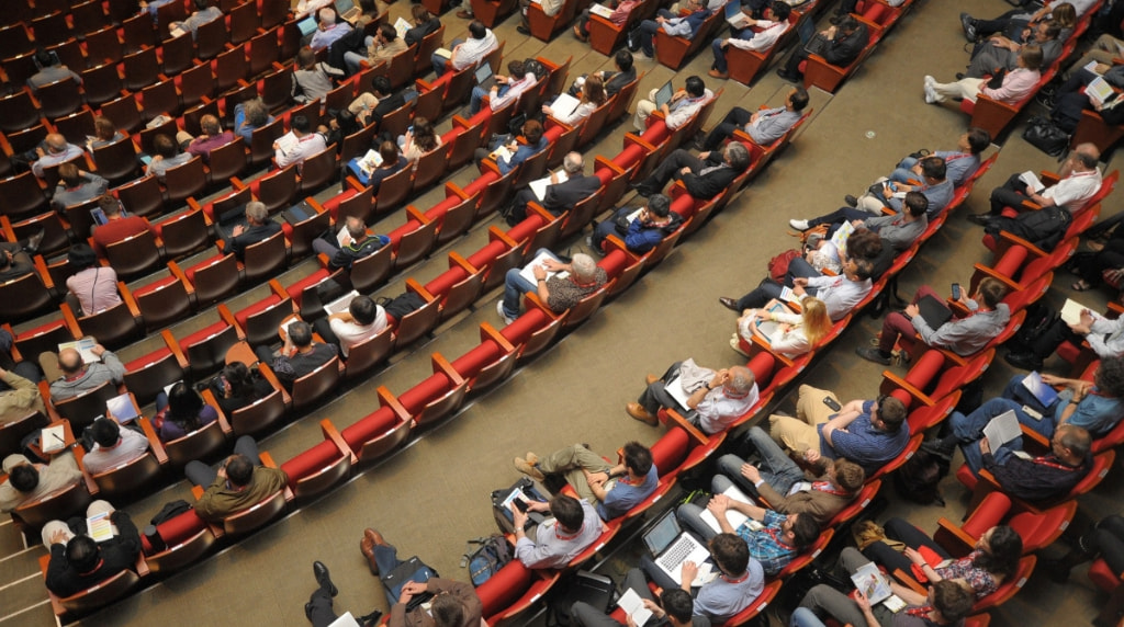 Audience Sitting in a Hall of an Event