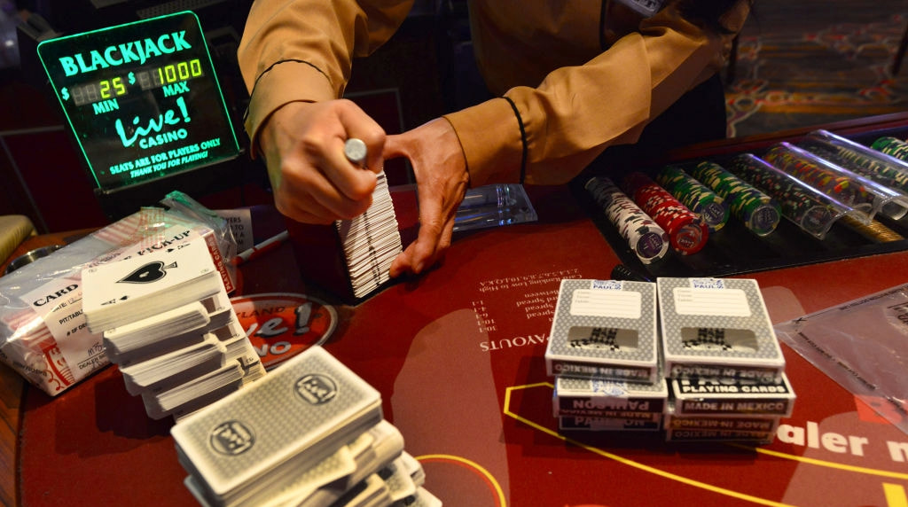 A Blackjack Dealer Seen Sorting through a Stack of Cards.