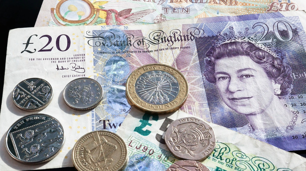 Various British coins on top of bank notes