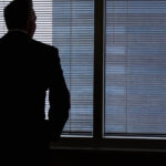 A Businessman Looking Out of a Window