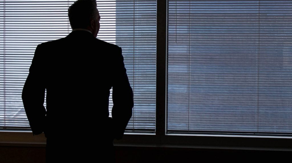 A Businessman Looking Out of a Window