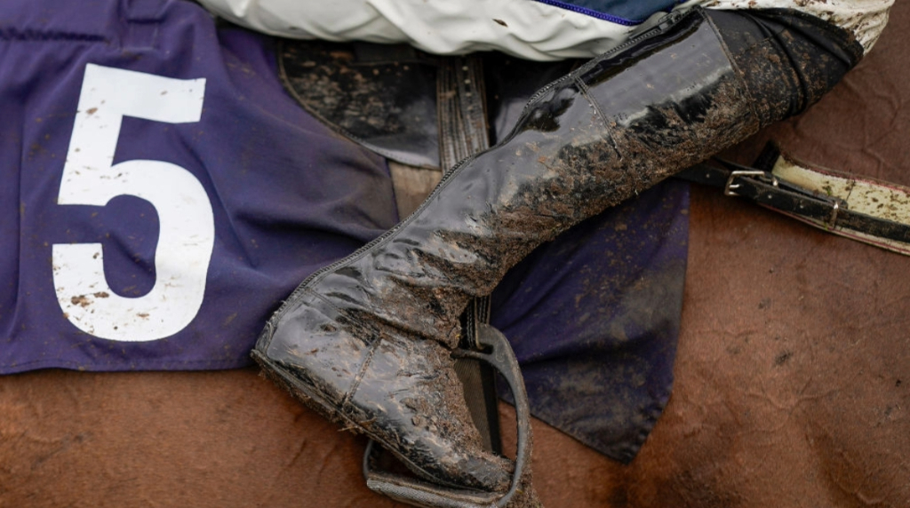 A mud splattered horse and rider's boot pictured at Fontwell Park in March, 2024