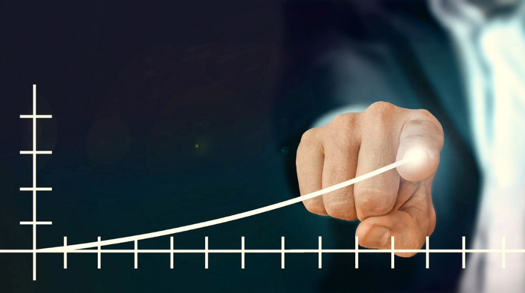 A Chart with a Human Hand Showing an Upward Trend