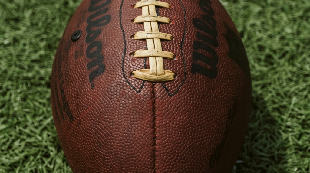 Football positioned on green field