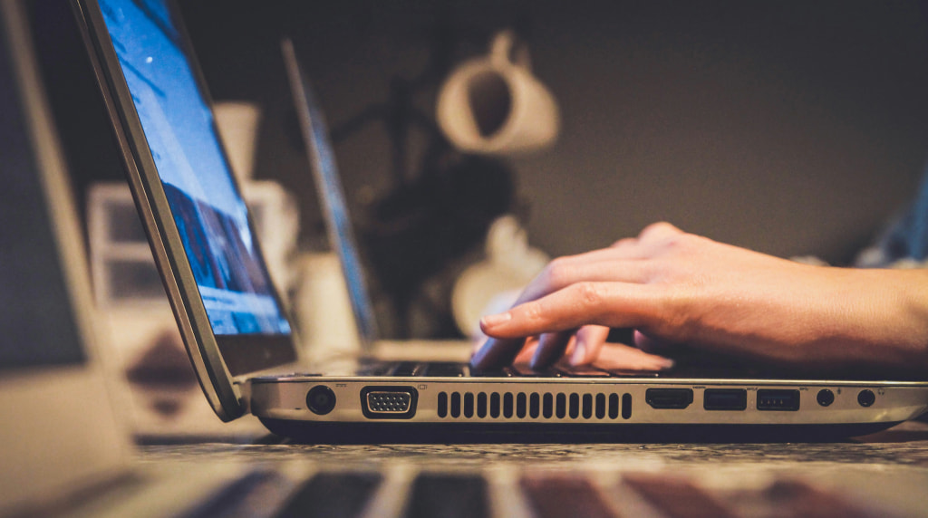 Person inputting information on a laptop computer