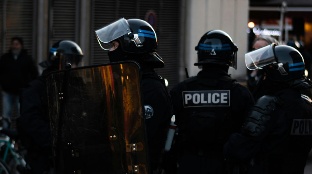 Police in riot gear protecting a public space