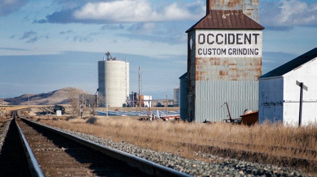 Grain Silos along railroad track in small town