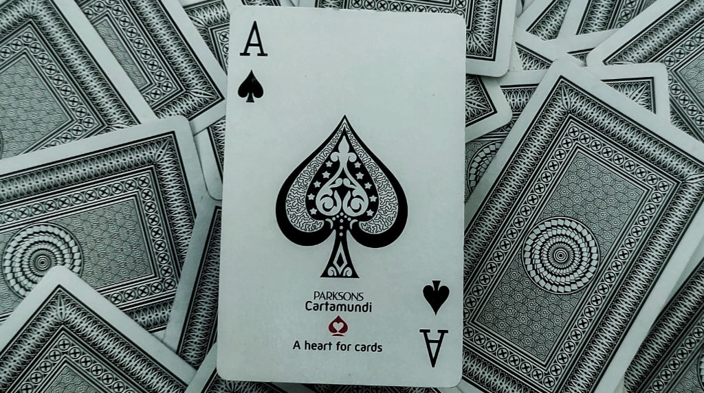 Face Up Ace of Spades Over Face Down Cards