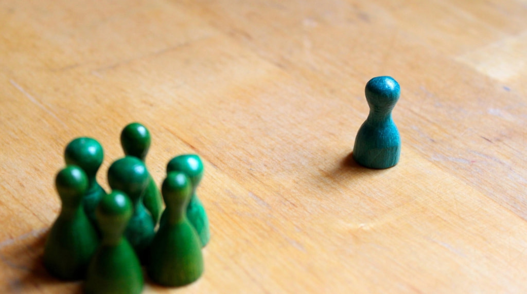 A Pile of Green Figures and One Blue Figure