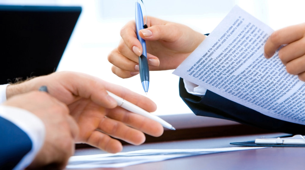 People in a meeting with documents