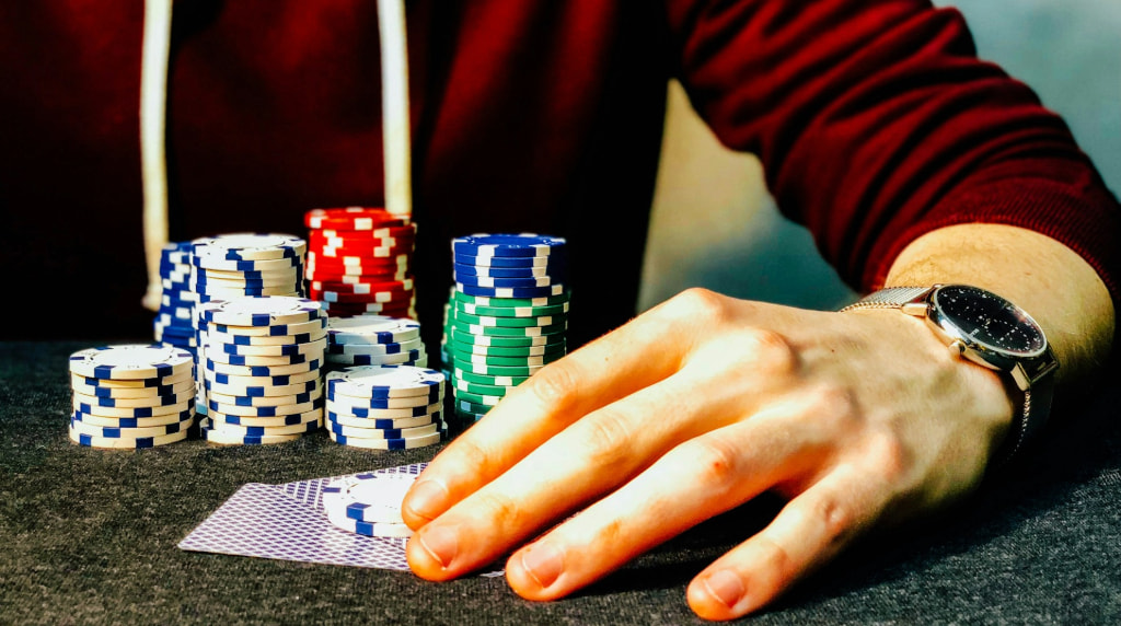 A Poker Player with a Stack of Chips and Cards