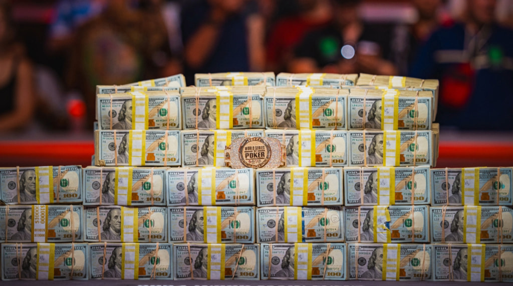 Piles of Cash and a WSOP Bracelet on Display.